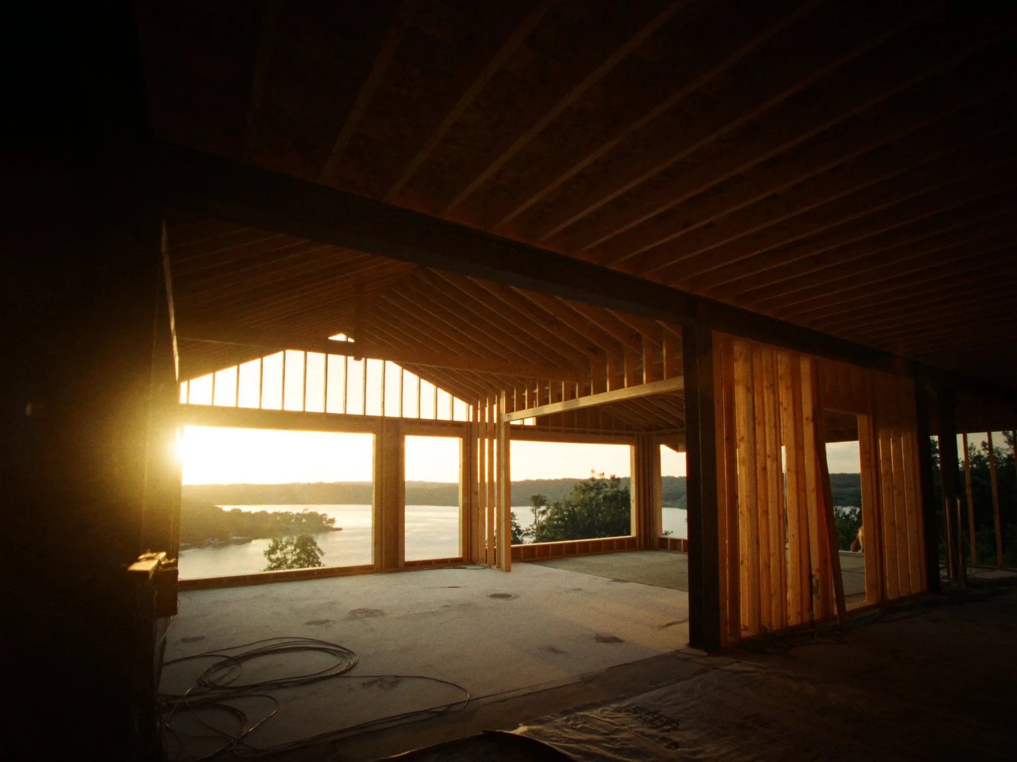 A residential construction site with conduits in place, captured at golden hour