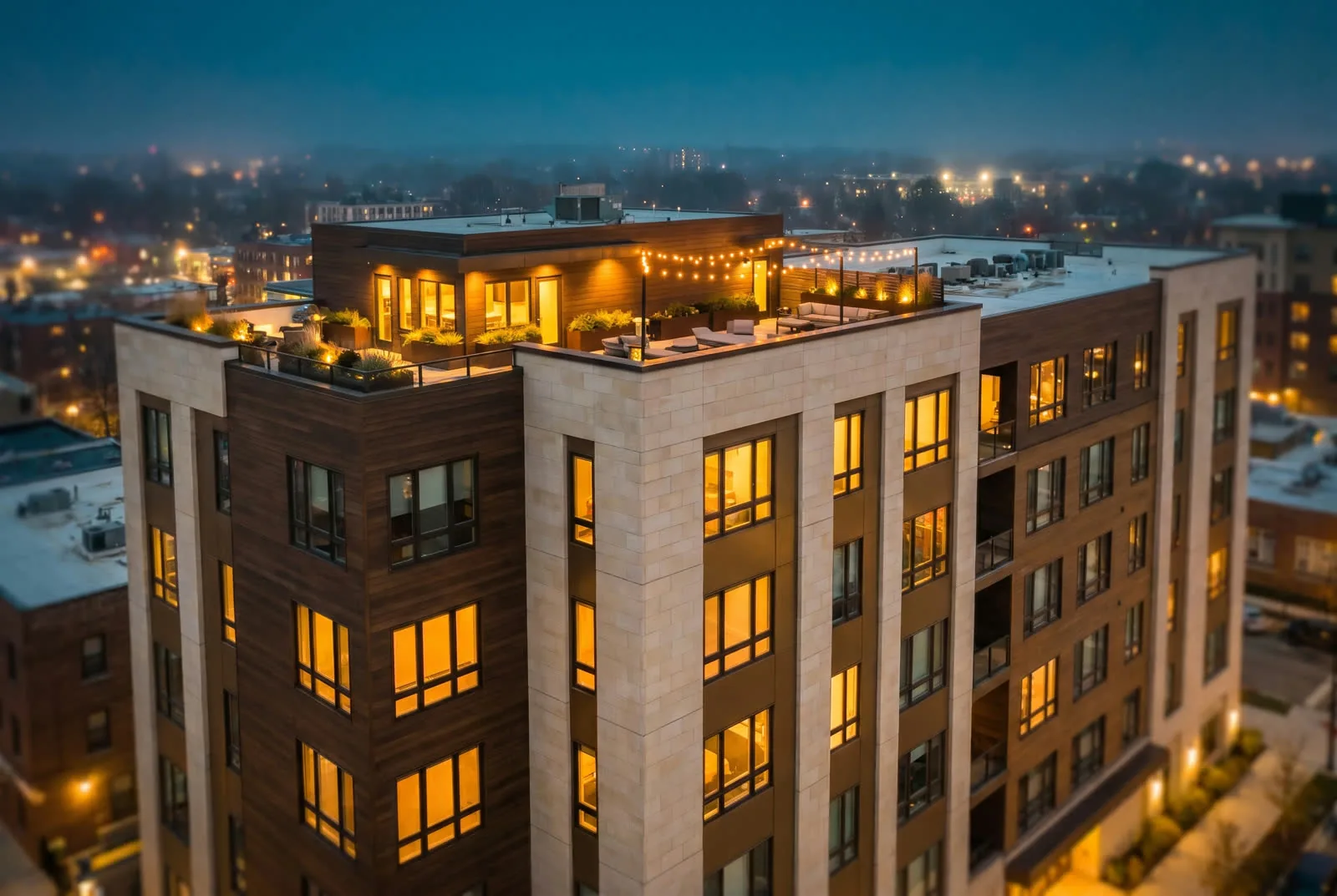 Aerial dusk view of a modern multi-family residential building