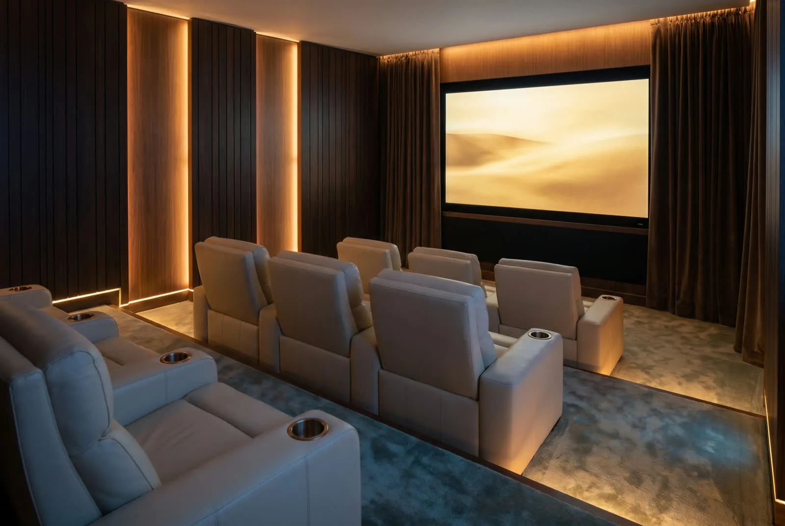 Private home cinema with walnut acoustic panels and theater seating
