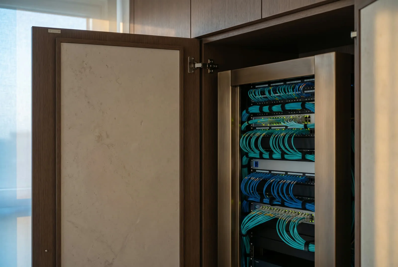 Architectural rack room with fiber, ethernet, and color-coded labels