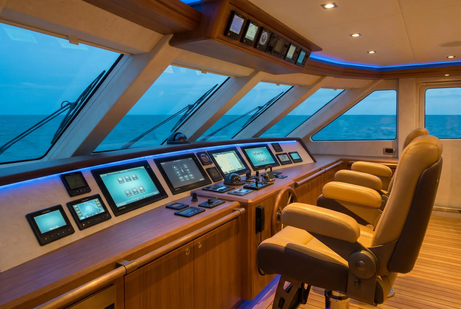 Superyacht bridge interior with Crestron touchscreens at blue hour