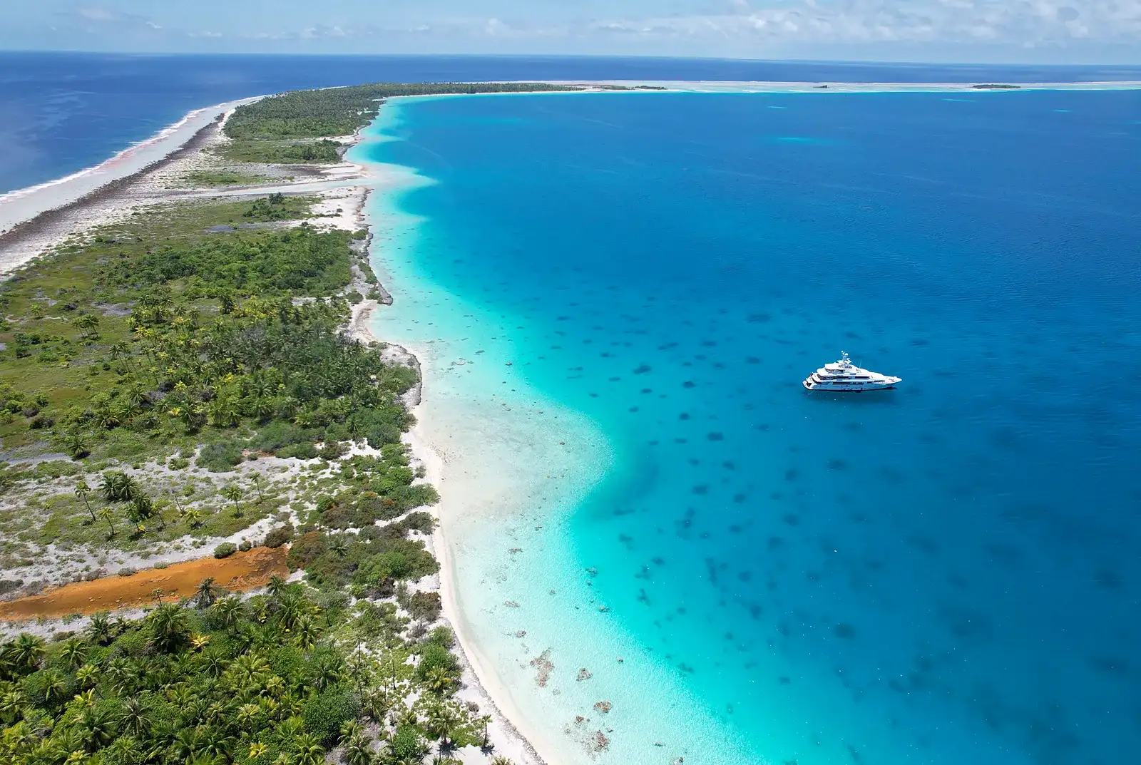Yacht anchored off a remote atoll — the kind of far-flung location our remote support systems are built to reach